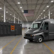 Workhorse electric delivery van parked in warehouse with branded generator unit and American flag