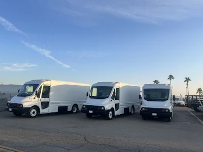 Three battery-electric Workhorse W56 step vans in a parking lot.