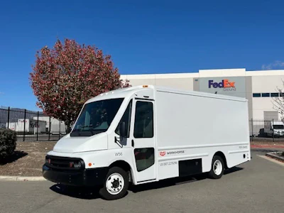 A white Workhorse W56 step van parked at a FedEx facility.