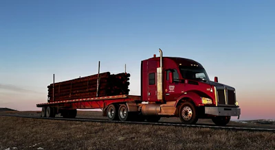 This Kenworth in Otto Transfer's fleet, hauling poles in its specialized operation, is no longer part of the all-Daimler power collection today. but certianly captures the company bread and butter over-the-road.