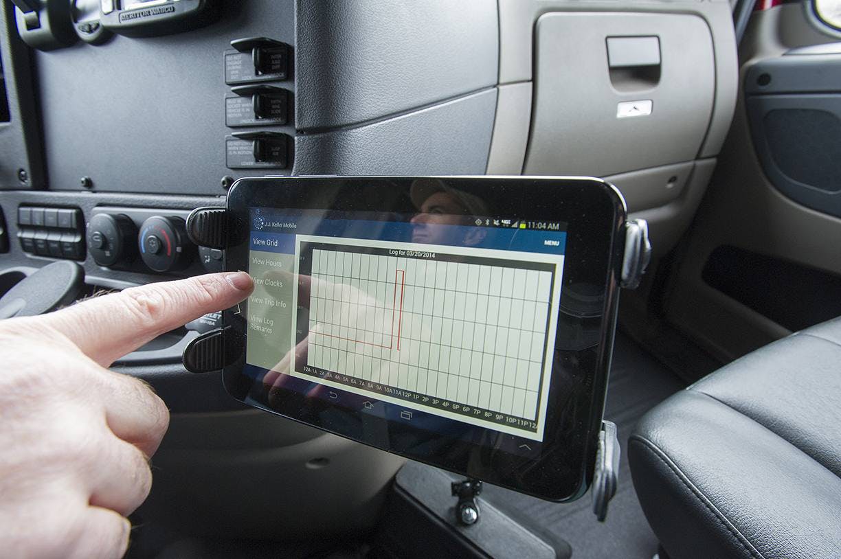 Smartphone mounted on truck dashboard displaying diagnostic chart application