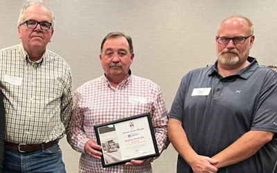 Pictured in December 2025, after one of Car Couriers' operators was named Driver of the Month by the Alberta Motor Transport Association, from left: Ron Spring, CEO/General Manager Gerry Neilon, and Darryl Cummings, dispatch and operations supervisor.