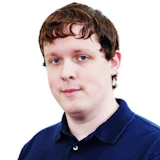 Professional headshot of a person with brown hair wearing a dark blue polo shirt against a white background
