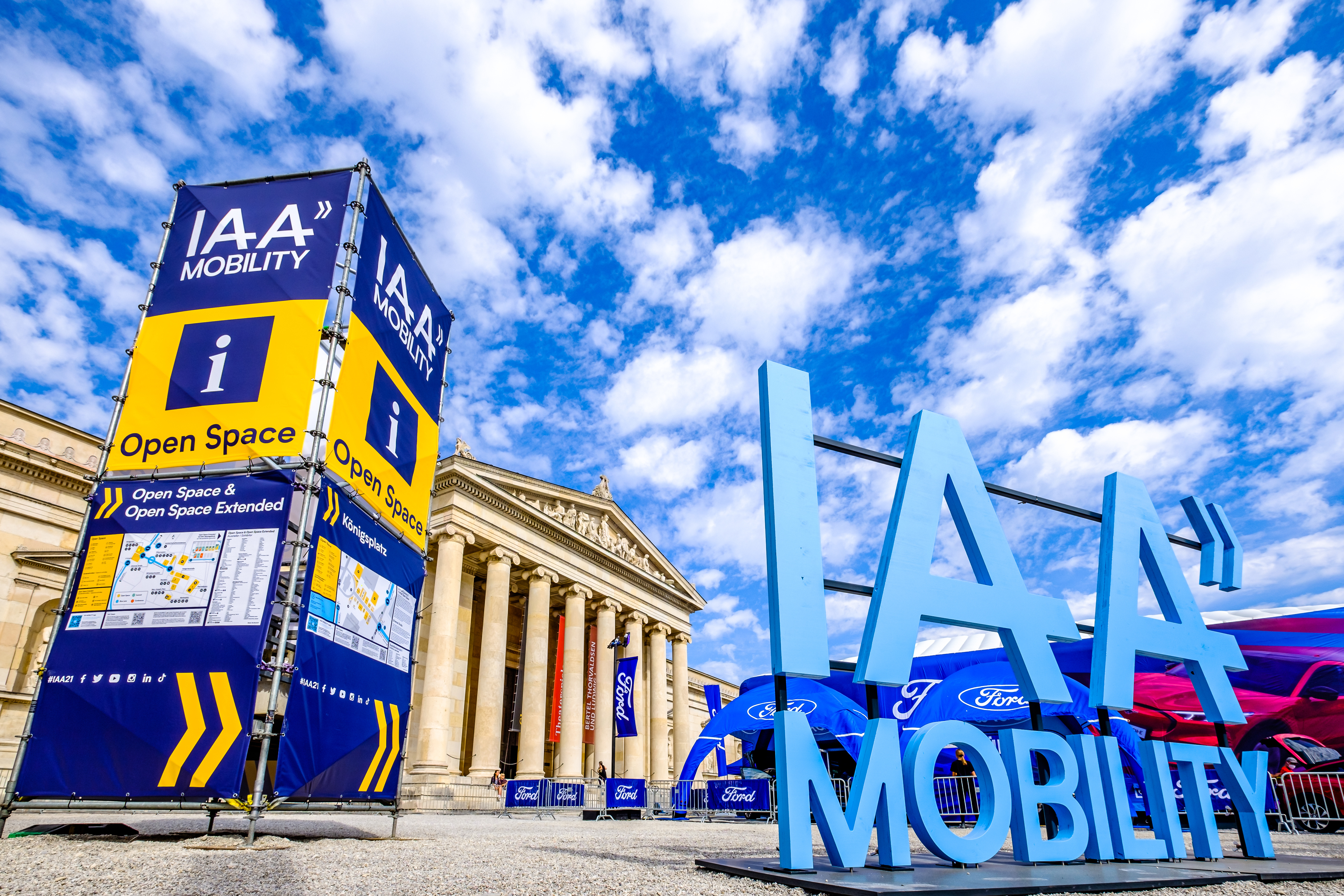 IAA Mobility exhibition entrance with blue Ford branding sign and classical building facade under cloudy sky