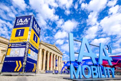 IAA Mobility exhibition entrance with blue Ford branding sign and classical building facade under cloudy sky