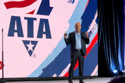 Professional speaker presenting at podium with ATA logo displayed on stage backdrop