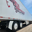 Bella Valley Transportation Solutions semi-truck trailer with red and blue branding and fuel economy tagline