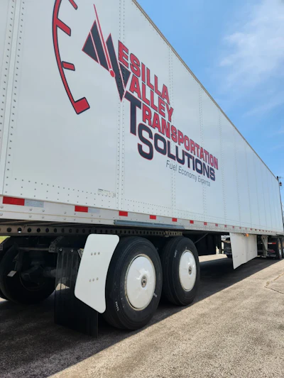 Bella Valley Transportation Solutions semi-truck trailer with red and blue branding and fuel economy tagline