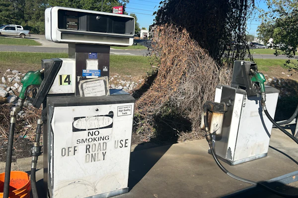 Vintage gas pumps numbered 14 with 'No Smoking' signage in outdoor setting