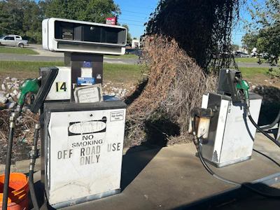 Vintage gas pumps numbered 14 with 'No Smoking' signage in outdoor setting