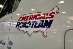 America's Roadteam logo decal on white RV exterior with red and blue text and map outline