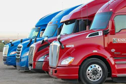Fleet of blue and red semi-trucks lined up with Knight Transportation branding displayed on vehicles