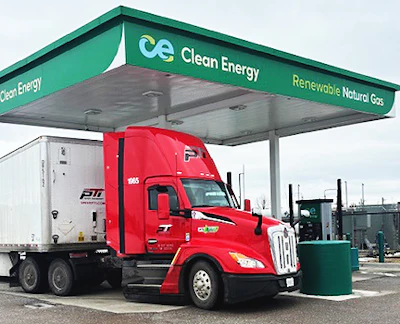 Red commercial truck refueling at Clean Energy renewable natural gas station